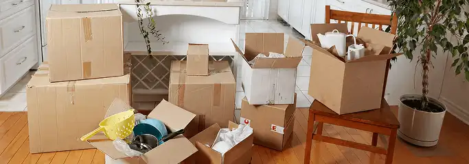 Packed moving boxes and household items in a kitchen before move-out or move-in cleaning, Bellevue, WA.